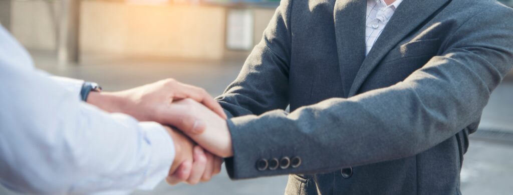 A handshake represents trust beyond leadership titles.