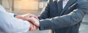 A handshake represents trust beyond leadership titles.